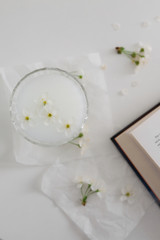 spring cherry blossoms on a white table with a book
