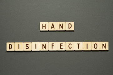 HAND DISINFECTION - words from wooden blocks with letters. Top view on gray background. - Image