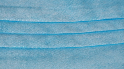 Close-up of the multilayer tissue of a surgical and medical mask. Disposable face mask protective against coronavirus, Covid-19, pollution, virus, and flu. Health care and surgical concept