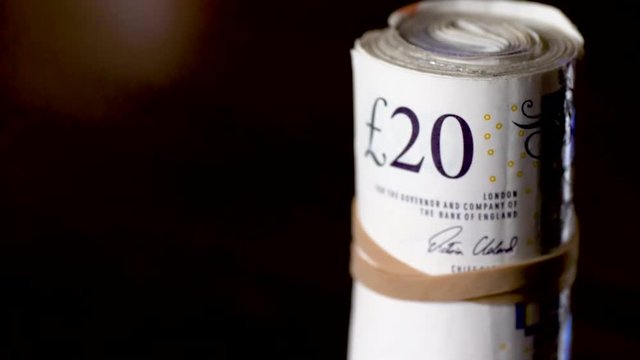 british sterling twenty pound notes roll pack. Focus pull. Money laundering concept.