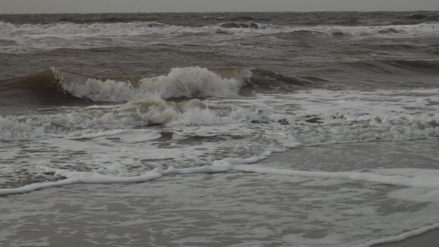 small waves are hitting the coast in slowmotion