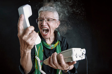 Portrait of old women, she holding phone and becoming crazy and angry, dispersion motion