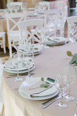 Festive table decor. With different natural colors and flowers. Luxury wedding, party, birthday. White, beige, golden. Candles.