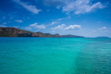 Fototapeta premium Phi Phi Lay island with tall cliffs and mountains, blue shy and white clouds ,Clear water and mountains,crystal clear Adriatic Sea and Blue Sky with White Clouds