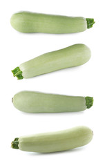 Set of fresh ripe zucchinis on white background