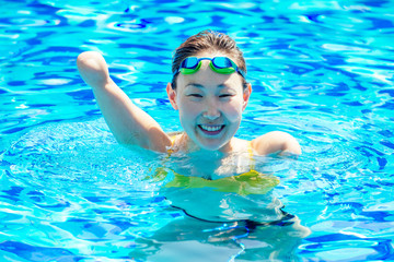 happy asian armless woman warming up before swimming at the tropical beach,she jumps