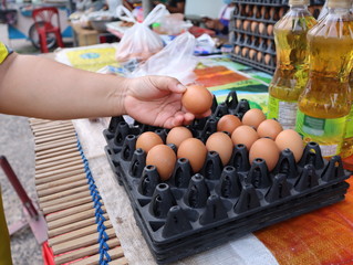 Women are choosing to buy eggs at the grocery store in the market.