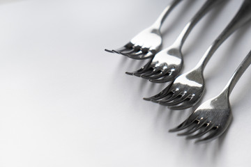 A silver forks on a white surface