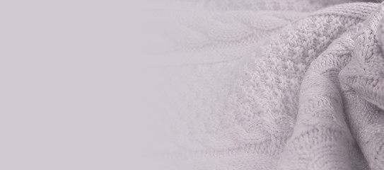 Soft blurred banner with wool texture. Perfect background for hotels, hobby, textile and home accessories store. Grey pastel color. Copy space.