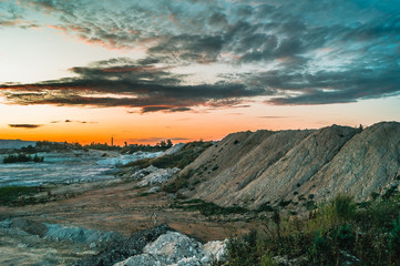 Industrial landscape with sunset over kaolin mining site in Hlukhivtsi, Ukraine