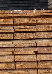 Piles of sawn wood. Piles of beam. Trade of wood. Building materials.