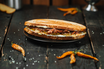 Tasty Oxtail Sandwich on a dark wooden background