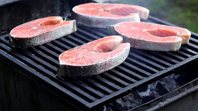 Fresh salmon steak fried on the grill. Tasty and healthy fish.