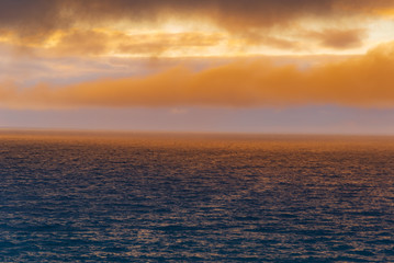 Naklejka na ściany i meble ocean sunset on the cliff