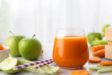 Glass with carrot juice, celery and green apple on the table. Diet, healthy eating, food and weigh...