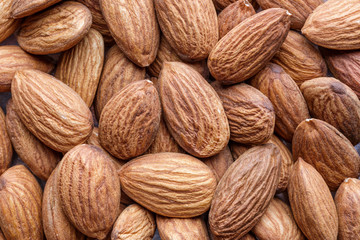 Organic almond nuts as background, top view. Healthy snack. For vegetarians.