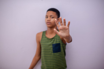 Teenager gesturing no with his hand