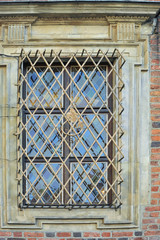 Window in a metal grate. Elements of the interior. Close-up. Background without sharpness