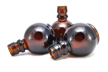 Brown glass bottle on a white background close up