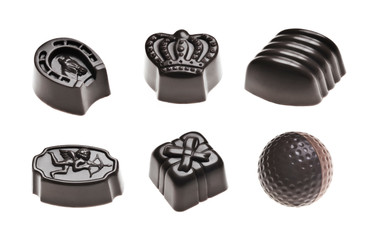 Luxury dark chocolate truffles. Assorted delicious handmade pralines in a row isolated on white. Studio shot. Close-up