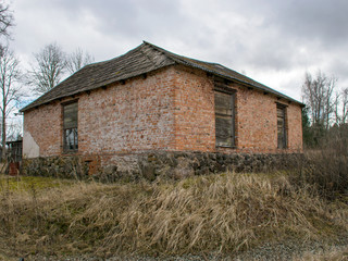 landscape with the ruins and details of an old red brick house