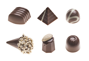 Luxury milk chocolate truffles. Assorted delicious handmade pralines in a row isolated on white. Studio shot. Close-up