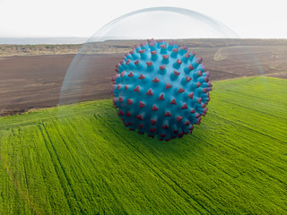 Coronavirus blue ball isolated under a glass transparent dome on a meadow