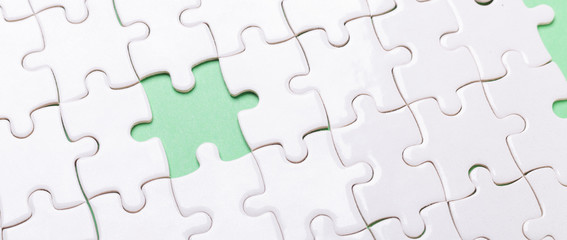 White puzzle background with one piece missing. Close-up. Concept success of business