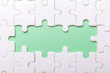 White puzzle background with pieces missing. Close-up. Copy space for text