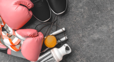 sport sneakers, leather boxing gloves, jump rope, ball, water