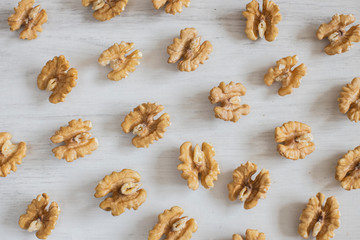Abstract mosaic of walnuts on a wooden background