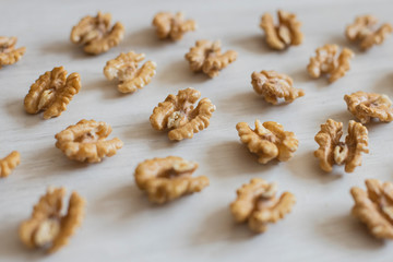 Abstract mosaic of walnuts on a wooden background