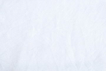 Naklejka na ściany i meble White fabric close up shot of Cotton and polyester shirt. Casual wear over the weekend or summer time season. Background texture concept with copy space for text.
