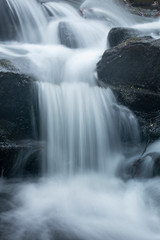 Fototapeta premium Silky, turbulent water of a small waterfall in Hebron, Connecticut.