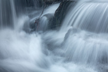 Fototapeta na wymiar Silky, turbulent water of a small waterfall in Hebron, Connecticut.