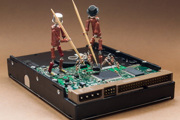 Two little men of resistors and transistors, symbolizing the antivirus program and firewall, fight...