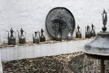 Metal containers for water and food in a traditional courtyard in Mostar, Bosnia, Europe