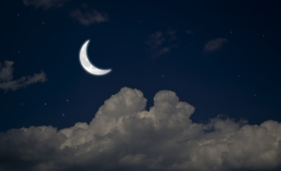 Evening crescent in the cloudy sky