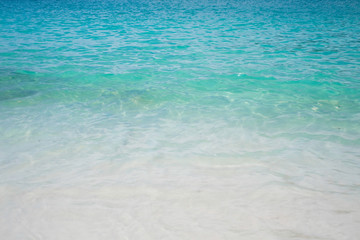 Fototapeta na wymiar Blue clear ocean (sea) water on sandy beach