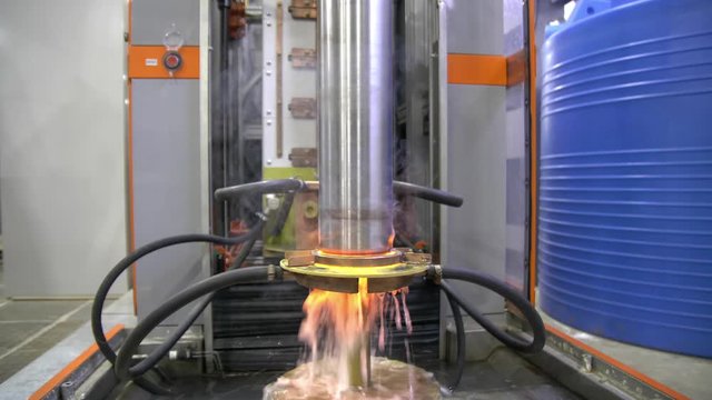 Metal induction hardening machine. Process of quenching metal with a high frequency current. Hardening of the steel shaft.