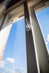 Obraz premium White plastic double glazing window and bright blue sky background
