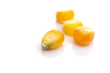 Raw Corn Seeds or Corn kernels isolated on white. Yellow Sweet grain popcorn - agriculture background. Detailed macro photo.