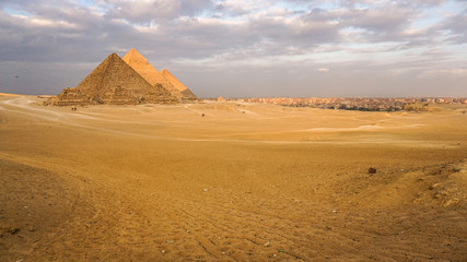 Fototapeta na wymiar Pyramids of Giza with Giza city view background