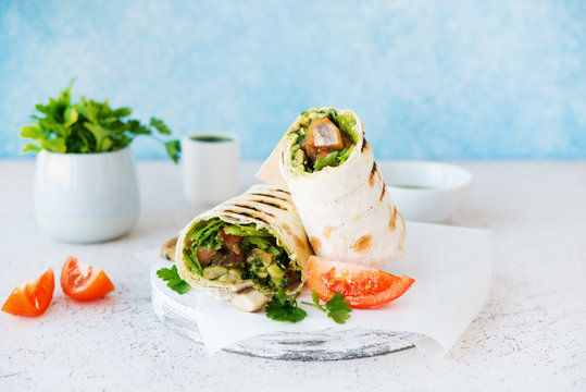 Burritos wraps with mushrooms and vegetables-traditional Mexican food.