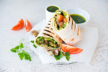 Burritos wraps with mushrooms and vegetables, a traditional Mexican food.