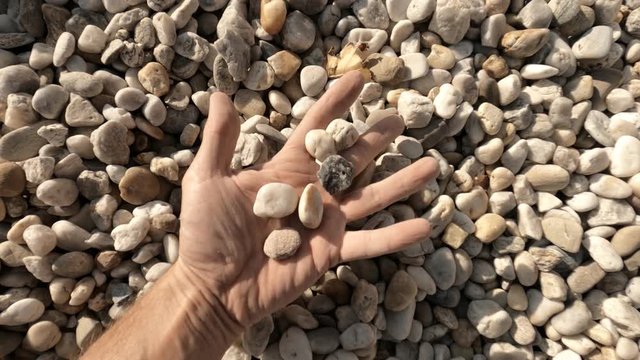 Man holds white gravel
