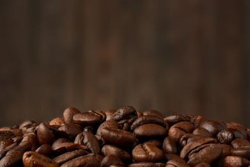 Fresh coffee beans on blurred background. roasted coffee beans background with focus foreground