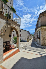 A narrow street between the old houses of a village in the province of Benevento, Italy