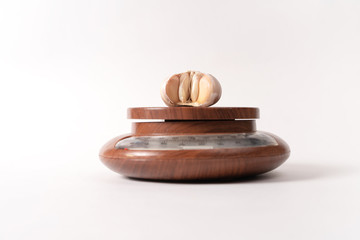 garlic lies on kitchen scales. white background
