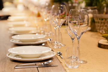 Table setting decor with cutlery, plates and glasses